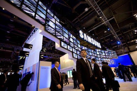 LAS VEGAS - JANUARY 8, 2009: People are walking under a large display of TVs at the 2009 Consumer Electronic Show held in Las Vegas, Nevada, on January 8, 2009.のeditorial素材