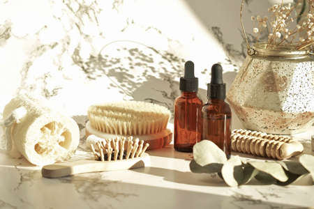 Zero waste. Bathroom accessories, natural brush, wooden comb, oil, makeup remover in a glass container, bamboo toothbrushes. Eco product concept.の写真素材