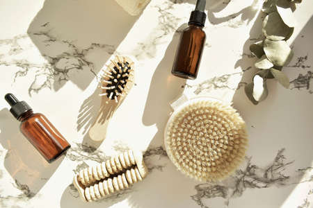 Zero waste. Bathroom accessories, natural brush, wooden comb, oil, makeup remover in a glass container, bamboo toothbrushes. Eco product concept.の写真素材