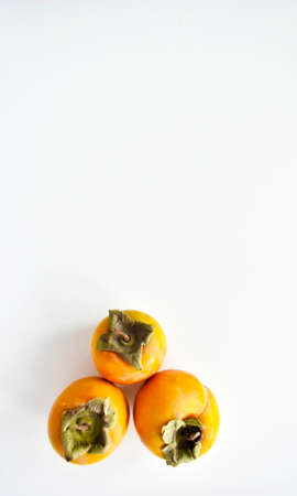 Ripe persimmon on a white background. Top view.の写真素材