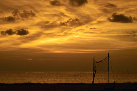 Volleyball court at sunset in the seaの写真素材