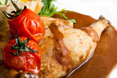 roast chiken with red tomatosの写真素材