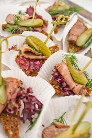 canape with meat and pickled cucumberの写真素材