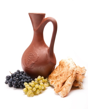 traditional clay jug for wine with grapes and lavashの写真素材