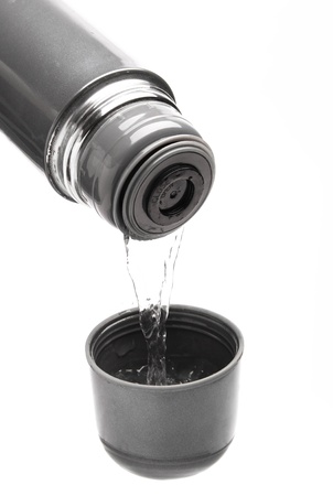 from thermos pour hot water in a cupの写真素材