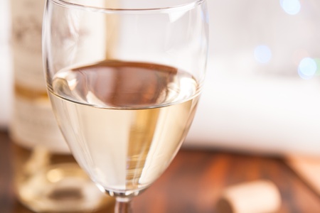 glass and bottle white wine on blink light backgroundの写真素材