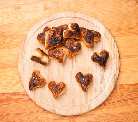 bakery hearts from split pastry on wooden boardの写真素材