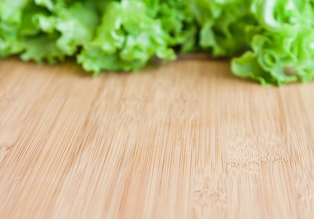 background with wooden board and lettuceの写真素材