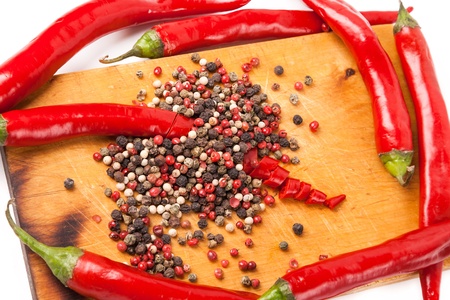 cut hot capsicum chili pepper and peppercorn on wooden boardの写真素材