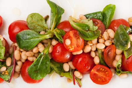 closeup salad from colored fresh vegetables on plateの写真素材