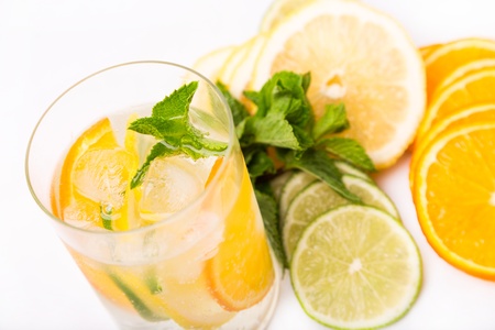 fresh cold cocktail in glass with sliced citusesの写真素材