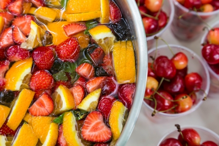 mixed punch with fresh fruits in metal bowlの写真素材