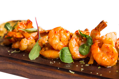 roasted hulled shrimps with leafs on dark wooden backgroundの写真素材