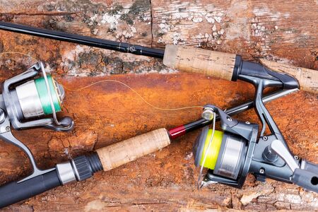 fishing rod and reel with line on natural background for frame, print, design