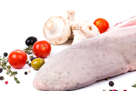 uncooked raw tongue with serving spices on white backgroundの写真素材