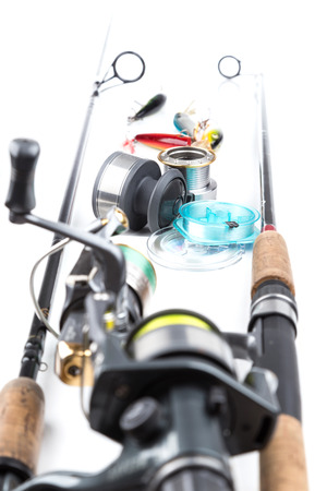 different fishing tackles - rod, reel, line and lures on white backgroundの写真素材