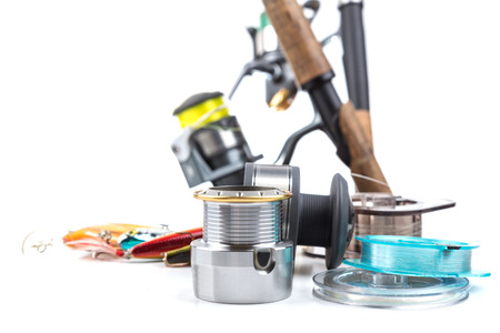 different fishing tackles - rod, reel, line and lures on white backgroundの写真素材