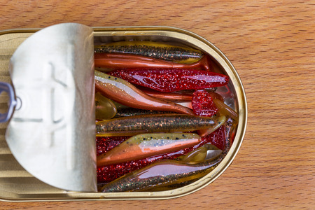 fishing tackles Swimbait different colors in open can on wood backgroundの写真素材