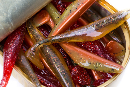 fishing tackles Swimbait different colors in open can on white background