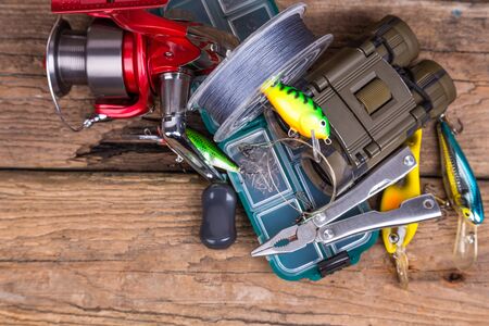 fishing tackles and tourism gear on timber board