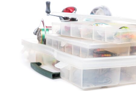 fishing baits and lure in transparent plastic storage boxes on bright white background. for design advertising or publicationの写真素材