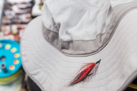 waterproof hat with fishing tackles on backgroundの写真素材