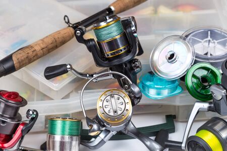 Different fishing tackles composition in storage box. Concept design for freshwater outdoor active business company.の写真素材