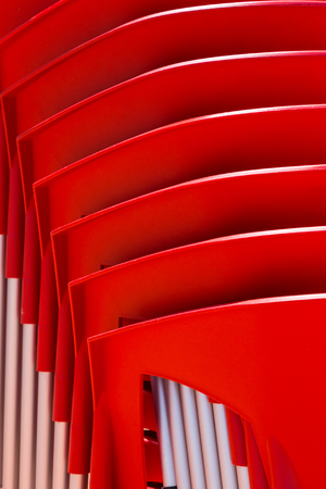 details of stack red chairs from hard plastic. abstract form for design or backgroundの写真素材