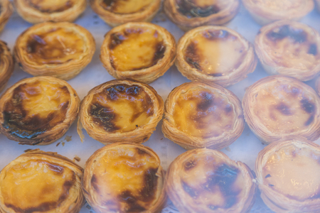 Traditional Portuguese egg tart pasty cake dessert Pasteis de nata on showcase in Lisbon, Portugal.