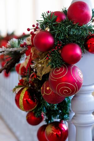 christmas balls decoration on white railing at homeの写真素材
