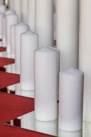 burning big candle in different size with flameの写真素材