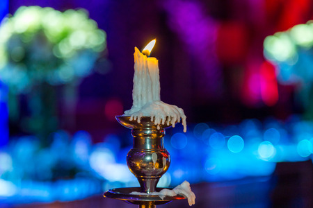 candle holder with burning candle on blur background