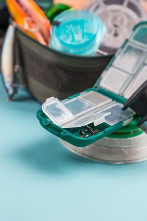 bright different fishing tackles on color paper background. outdoors activity sport and relaxの写真素材