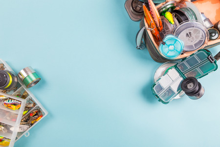 bright different fishing tackles on color paper background. outdoors activity sport and relaxの写真素材