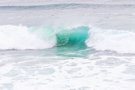 Ocean coast, moviment waves with foam. Wind power. Turquoise water. 