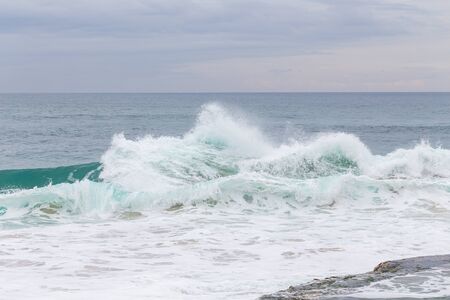 Ocean coast, moviment waves with foam. Wind power. Turquoise water. 
