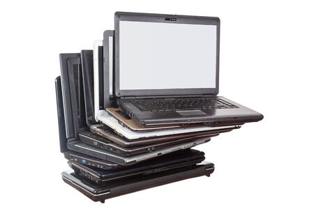 Stack of used laptops in different colors and models. Tha notebooks for repair and service.