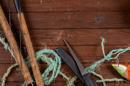 Fishing tacles on wooden background. Mockap for advertisment and publishing.