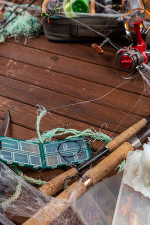 Fishing tacles on wooden background in Halloween designe with spaders and web. Mockap for advertisment and publishing.の写真素材