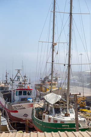 Sesimbra, Setubal, Portugal - September 01, 2021: Fishing port, a place of repair and parking of ships and boats. Daylight on the background of nature.のeditorial素材