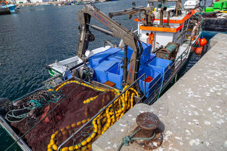 Sesimbra, Setubal, Portugal - September 01, 2021: Fishing port, a place of repair and parking of ships and boats. Daylight on the background of nature.のeditorial素材