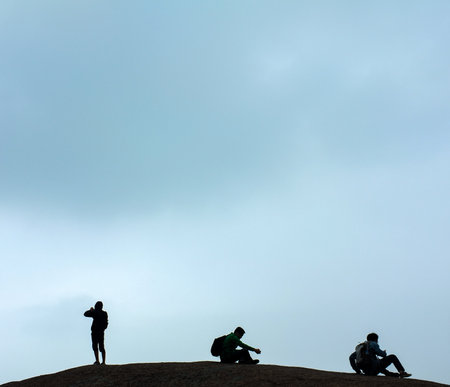 Silhouette of a group of people on the top of the mountain.の写真素材