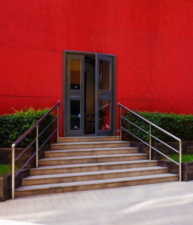 Entrance of a modern office building with a door and stairs.の写真素材