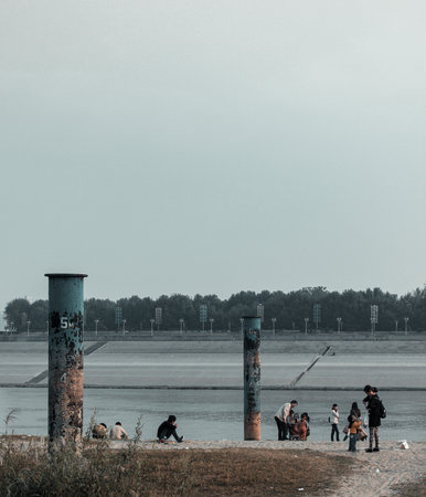 People sitting on the bank of the river and waiting for the busの写真素材