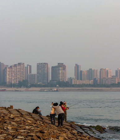 People fishing on the river bank.の写真素材