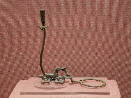 Antique bronze candlestick on a red background, close-upの写真素材