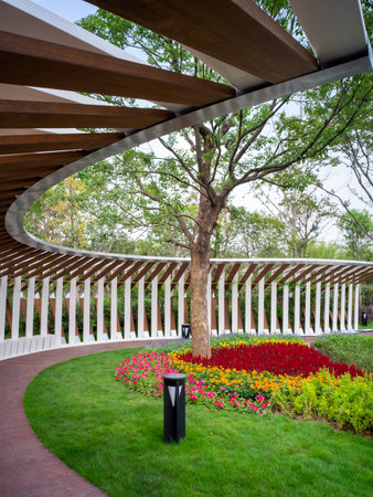 Beautiful view of the park with wooden fence and green lawn.の写真素材