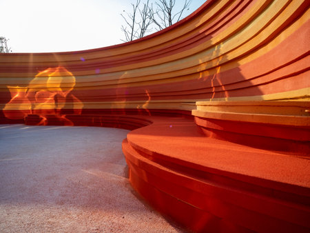 abstract scene with red and orange stairs in a park at sunsetの写真素材