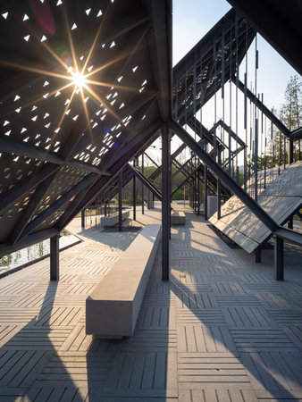 Sunlight over the stairs of a pedestrian bridge in the park.の写真素材