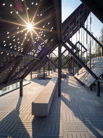Sunset in the city park. Perspective view of the pedestrian bridge.の写真素材